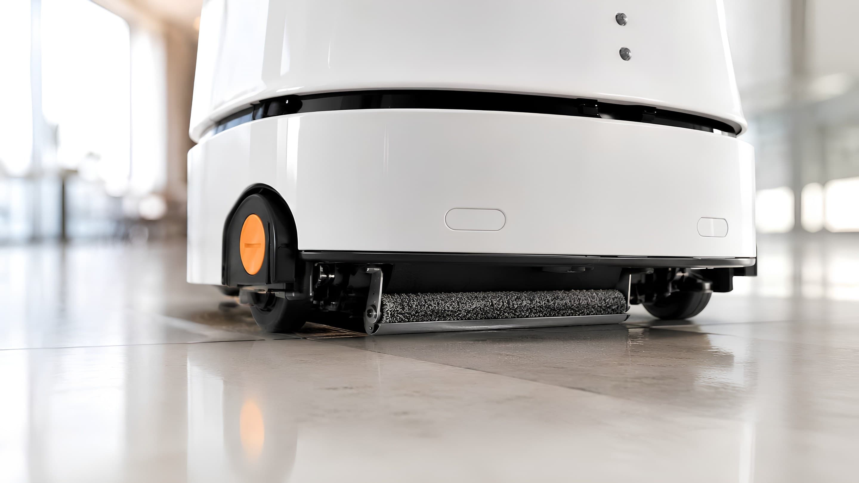 Close-up of the roller brush and squeegee drying a polished floor